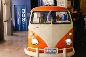 an orange and white van parked in a room at Joy Hostel & Suítes in Brasília