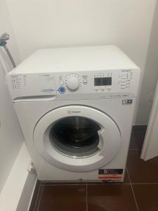 a white washing machine sitting in a room at réf rog Chambre Privée dans une villa partagée in Magny-le-Hongre