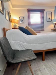 a large bed and a chair in a bedroom at Petit Bonheur - Calm Intimate - Terrace & Beach in Puerto Vallarta +35 photos