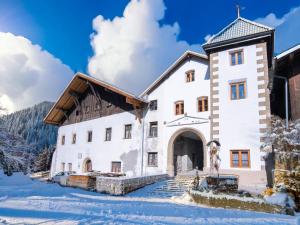 a large white building in the snow at Schloss Sissi - S in Pfunds