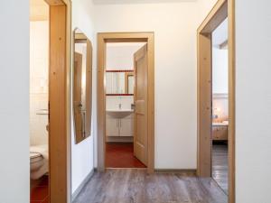 a bathroom with two open doors and a sink at Landhaus Marchfeld Top 2 in Wildschönau +30 photos