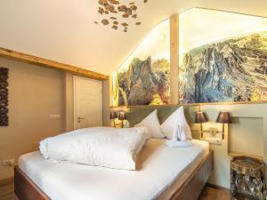 a bedroom with two beds and a painting on the wall at Schloss Sissi - S in Stuben