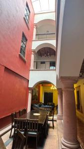 a room with a table and chairs in a building at Hotel San Rafael in Querétaro