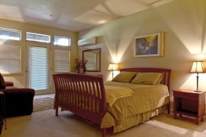 a bedroom with a bed and two lamps and a chair at Widgi Creek #22 condo in Bend +28 photos