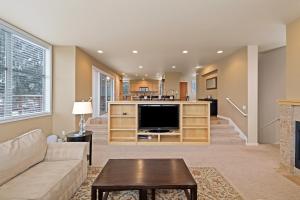 a living room with a couch and a tv at Presidio Park home in Redmond