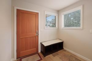 a room with a door and a bench and windows at Presidio Park home in Redmond