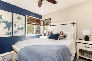 a bedroom with a large bed with a blue wall at The Dome Home - 3BR House 1mi to ND in South Bend