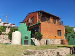 ein Backsteingebäude mit Balkon darüber in der Unterkunft Casa en las Sierras de Cordoba in Villa Parque Siquiman