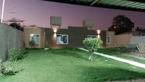 a house with a green lawn in front of it at Sol de Abril in Russell +2 photos