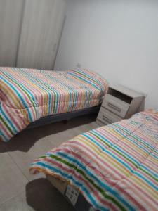two beds sitting next to each other in a room at Sol de Abril in Russell