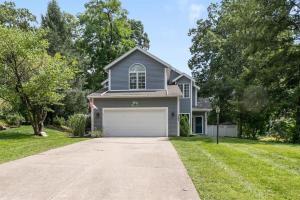 a blue house with a garage in a yard at The Victory Lounge - 3B 3BA - Close to ND in South Bend