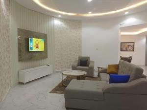a living room with a couch and a table at Aquarian Spring Homes in Ikeja