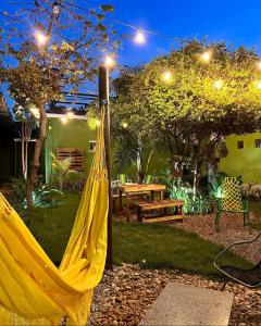 a yellow hammock in a garden at night at Morada do Lago in Palmas
