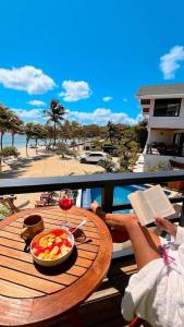 a table with a bowl of fruit and a glass of wine at Curacion Beach Resort in Brick Bay