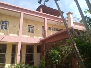 a large house with a balcony in front of it at La Villa sûr in Niamey