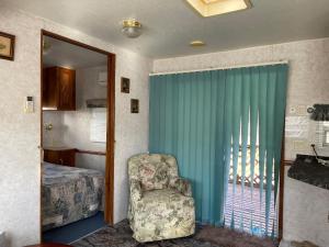 una camera da letto con un letto, una sedia e una finestra di Camp inn Kiyosato GRANDEUR - Vacation STAY 42079v a Hokuto