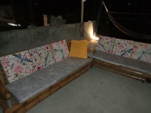 a bench with a yellow pillow sitting on it at la terraza in Armenia