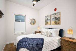 a white bedroom with a bed and a window at Ebb920 Modern Loft, Heart of Taft District in Lincoln City
