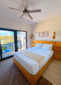 a bedroom with a large bed with a ceiling fan at Curacion Beach Resort in Brick Bay