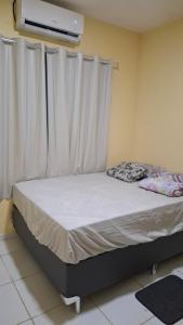 Ένα ή περισσότερα κρεβάτια σε δωμάτιο στο Apartamento Condomínio Macapá