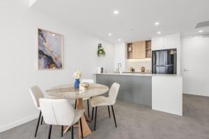 a kitchen and dining room with a table and chairs at Stylish Woden 2BR, Near Hospital, CIT, Westfield in Phillip