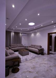 a large living room with couches and a table at Al-Shmoukh Hotel in Abha
