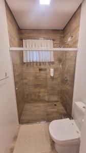 a bathroom with a shower and a toilet at Hospedaria Alpina in Treze Tílias