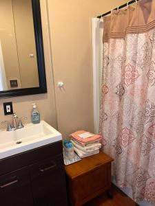 a bathroom with a sink and a shower curtain at Amazing Wood streets studio in Riverside