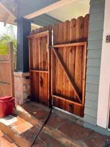 a fence with a wooden door on a house at Amazing Wood streets studio in Riverside