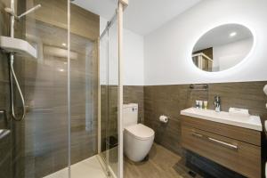 a bathroom with a toilet and a glass shower at Mount Views, Close To Wanaka Attractions -Love It! in Wanaka +19 photos