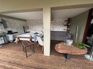 a bedroom with a bed and a table in a room at TsiaBie Hotel in Choachí +39 photos