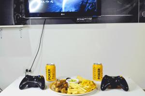 a table with a plate of food and two video game controllers at Hotel Elimar in Girardot
