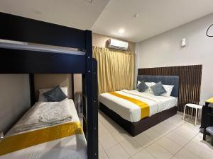 a bedroom with two bunk beds and a desk at SS Grey Hotel BBKL in Kuala Lumpur