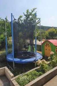 a playground with a blue trampoline in a yard at Apartments with parking space Palit, Rab - 22676 in Rab