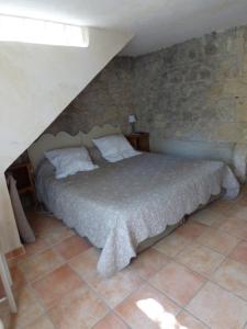 ein Schlafzimmer mit einem Bett im Dachgeschoss in der Unterkunft Domaine Chanoine Rambert in Saint-André-dʼOlérargues