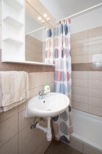 a bathroom with a sink and a bath tub at Apartments with parking space Palit, Rab - 22676 in Rab +34 photos