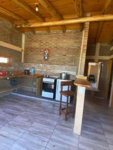 a kitchen with a stove and a table in a room at cabaña Mirador in Bialet Massé