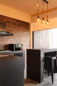 a kitchen with a black and gray counter top at Bonito departamento en Avandaro in Valle de Bravo +8 photos