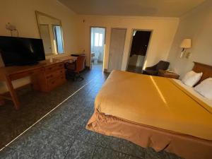 a hotel room with a bed and a desk and a television at Econo Lodge in Fairfield