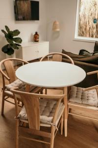 a white table and chairs in a living room at Salt Cottage in Port Fairy +6 photos