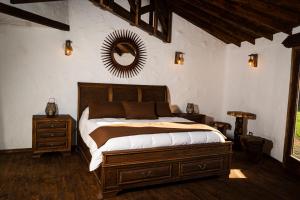 a bedroom with a bed and a mirror on the wall at Antu Wellness cabaña de lujo en paine in Maipo +31 photos