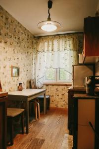 a kitchen with a table and a window at Karja Apartment Narva-Jõesuu in Narva-Jõesuu