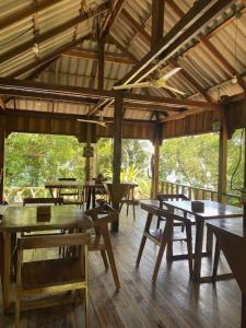 a dining room with tables and chairs in a building at Lily's Blue View in Koh Rong