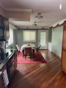 a kitchen with a table and chairs in a room at Splendid Room in House 10 mins to Airport in Saint Louis +11 photos