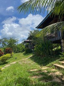 a dirt road next to a house in a field at Lily's Blue View in Koh Rong