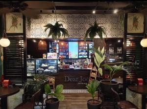 a restaurant with potted plants in front of a counter at Serene Suites Condo unit in Bacoor