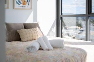 a bedroom with a bed with two towels on it at Sunny Central Woden Apt,Hospital, CIT , Pool in Phillip +21 photos