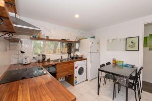 a kitchen with a table and a sink and a refrigerator at Spacious King Studio Room in Carramar - Nearby Station & Shops - Shared Bathroom and Kitchen in Villawood +14 photos