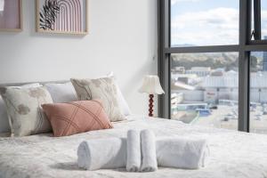 a bedroom with a large bed with a large window at Mountain View Woden Apt, Hospital, Westfield in Phillip +22 photos