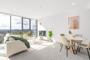 a living room with a table and chairs at Mountain View Woden Apt, Hospital, Westfield in Phillip